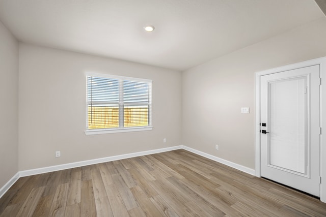 unfurnished room with light hardwood / wood-style floors