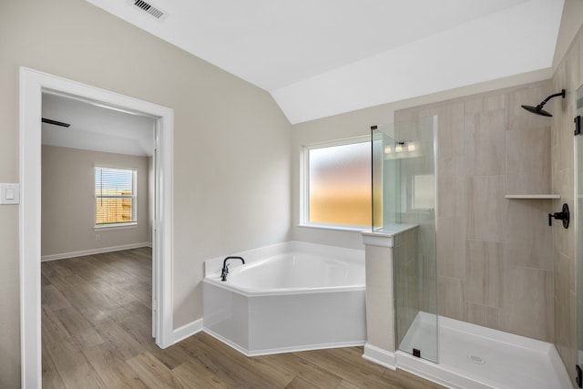 bathroom with plus walk in shower, vaulted ceiling, and hardwood / wood-style flooring