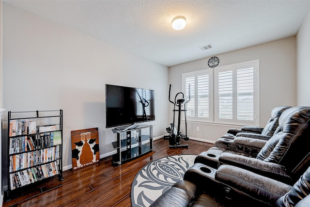 living room featuring a textured ceiling and dark hardwood / wood-style flooring