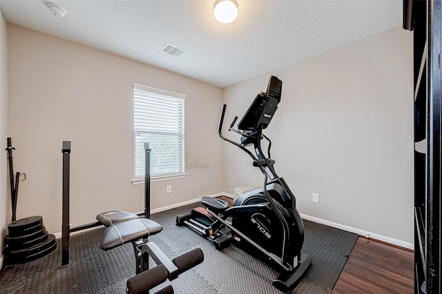 exercise area featuring dark hardwood / wood-style flooring