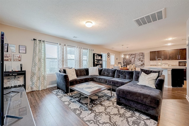 living room featuring a textured ceiling and hardwood / wood-style flooring