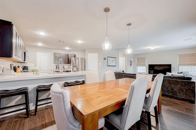 dining space featuring dark hardwood / wood-style flooring and sink