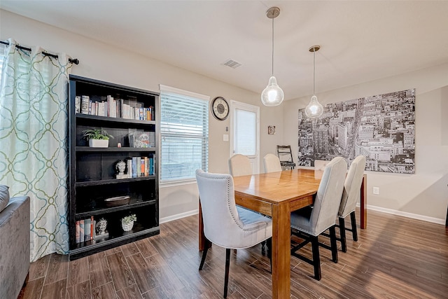 dining room with dark wood-type flooring