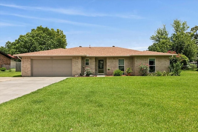 ranch-style house with a garage and a front lawn