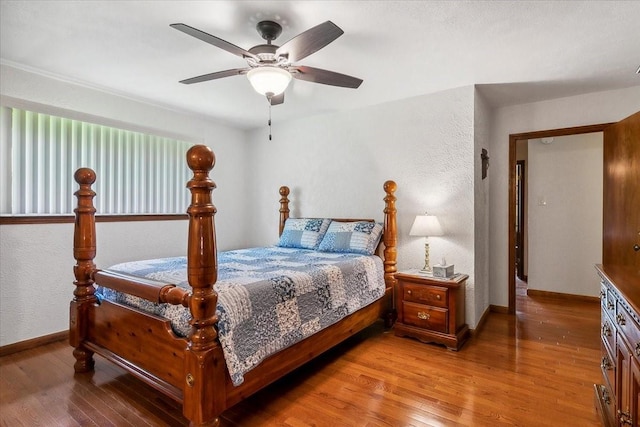 bedroom with ceiling fan and hardwood / wood-style floors