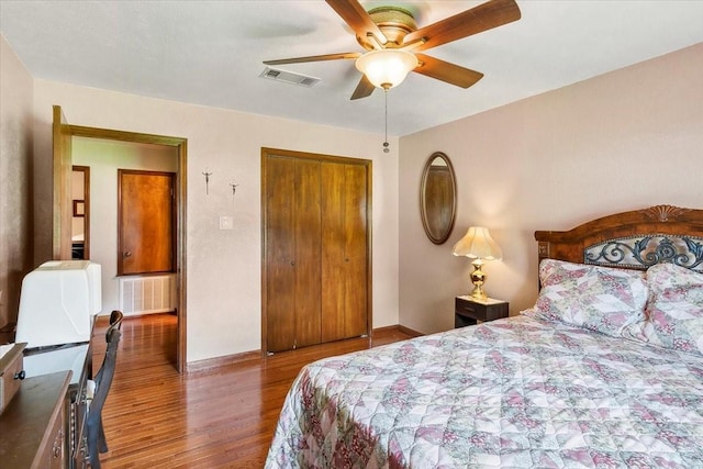 bedroom featuring a closet, ceiling fan, and dark hardwood / wood-style floors