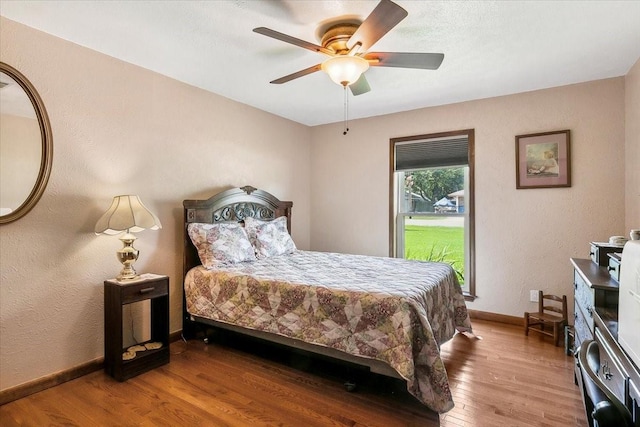 bedroom with hardwood / wood-style floors and ceiling fan