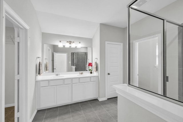 bathroom featuring tile patterned floors, vanity, and an enclosed shower