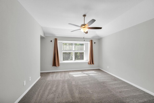 unfurnished room featuring carpet, vaulted ceiling, and ceiling fan