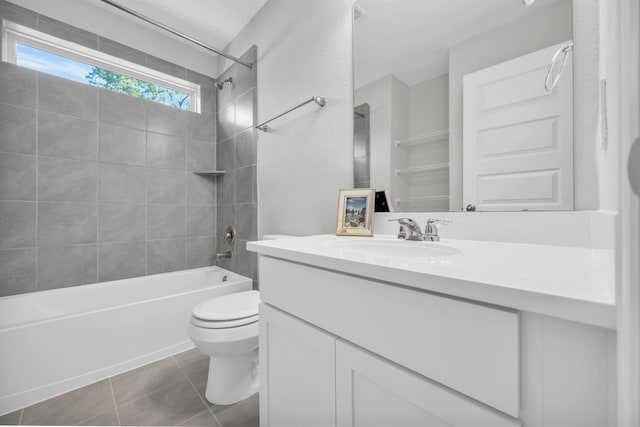 full bathroom featuring tile patterned flooring, vanity, toilet, and tiled shower / bath