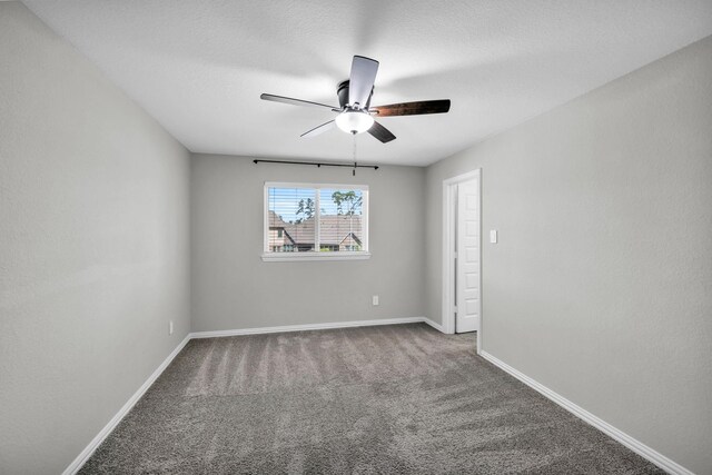 empty room featuring carpet flooring, ceiling fan, and a textured ceiling