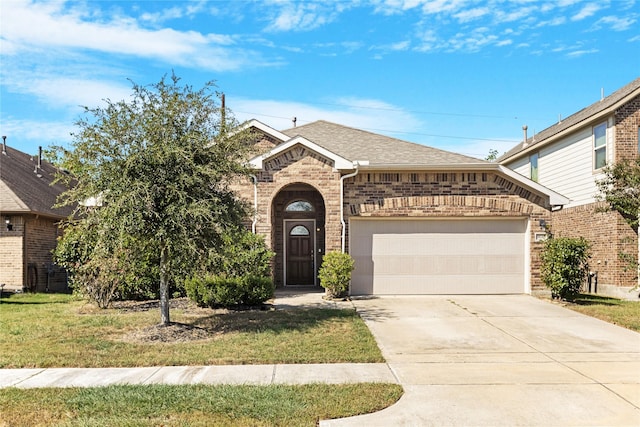 view of front of home featuring a garage and a front lawn