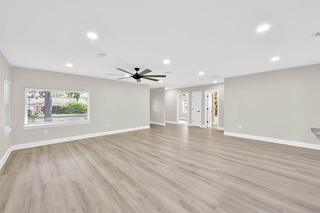 unfurnished living room featuring ceiling fan and light hardwood / wood-style floors