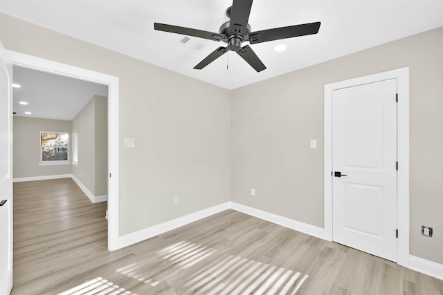 spare room featuring light wood-type flooring and ceiling fan