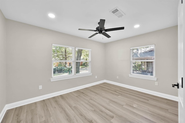 spare room featuring ceiling fan and light hardwood / wood-style flooring