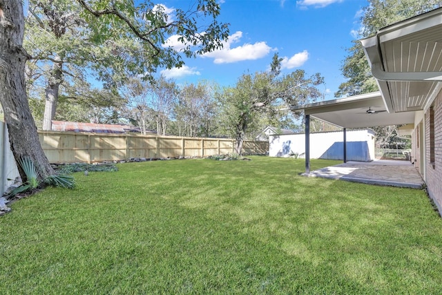 view of yard featuring a patio and ceiling fan