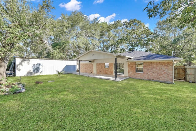 rear view of property with a patio and a lawn