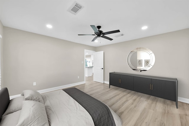 bedroom with light hardwood / wood-style floors and ceiling fan