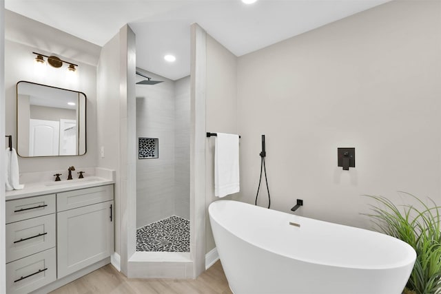 bathroom with shower with separate bathtub, vanity, and wood-type flooring