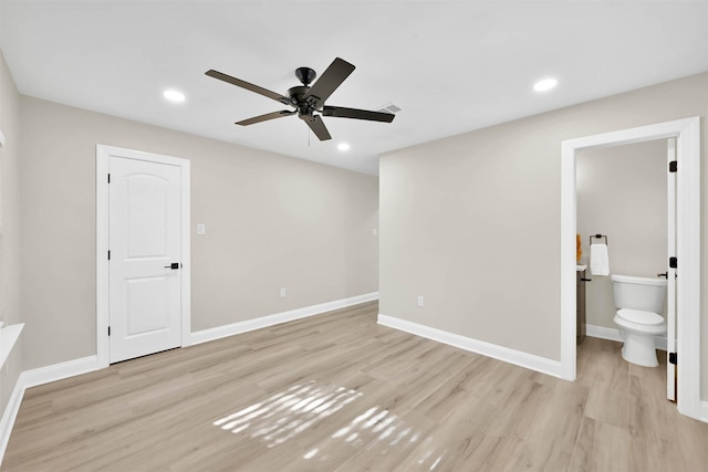 unfurnished bedroom featuring ensuite bath, ceiling fan, and light wood-type flooring