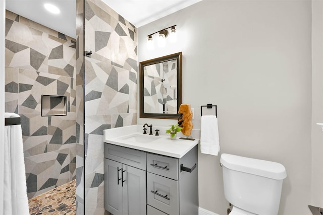 bathroom featuring vanity, an enclosed shower, and toilet