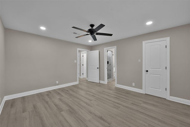 unfurnished bedroom with light wood-type flooring, ceiling fan, and connected bathroom