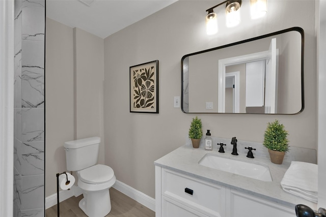 bathroom with a shower, wood-type flooring, vanity, and toilet