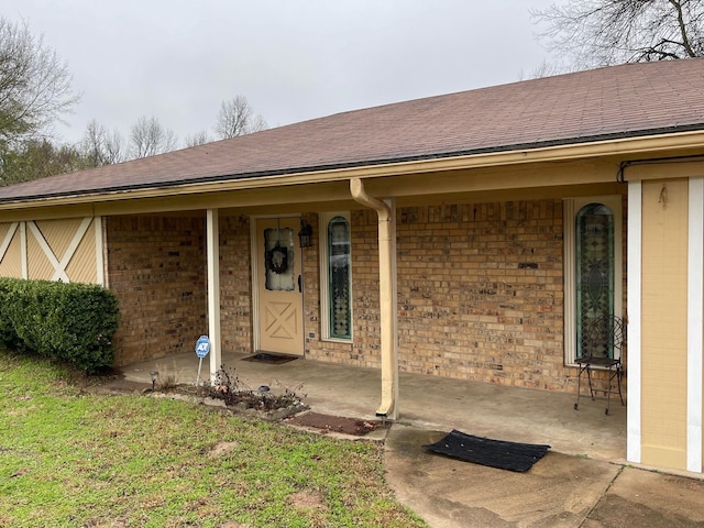 view of exterior entry with a porch