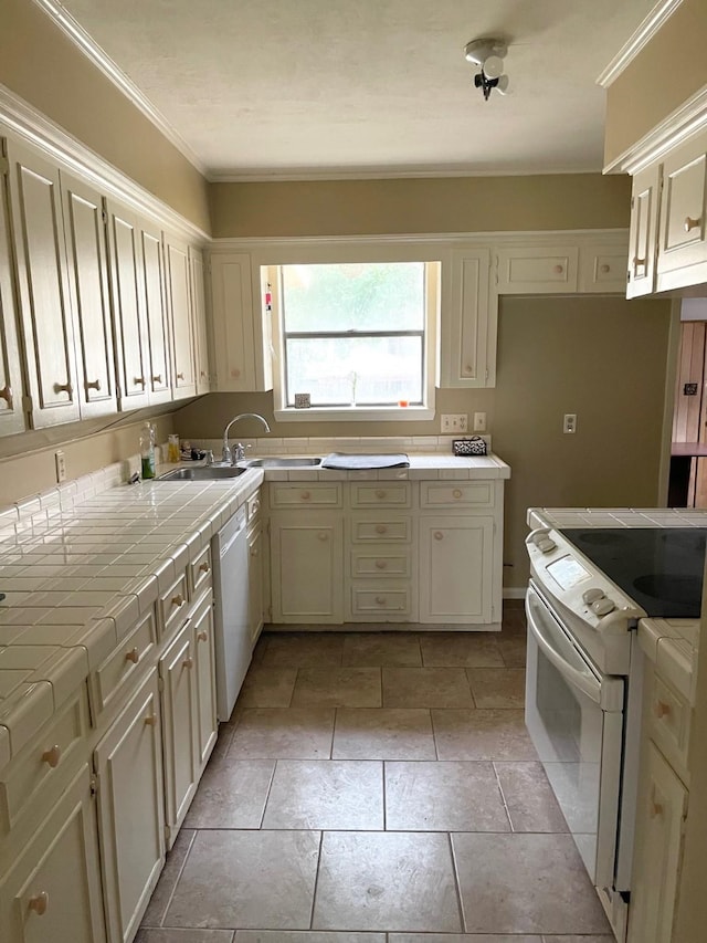 kitchen featuring tile counters, light tile patterned flooring, white appliances, and crown molding