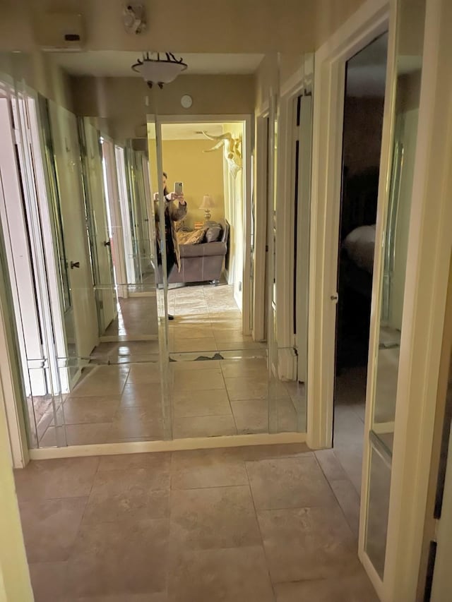 corridor with light tile patterned floors