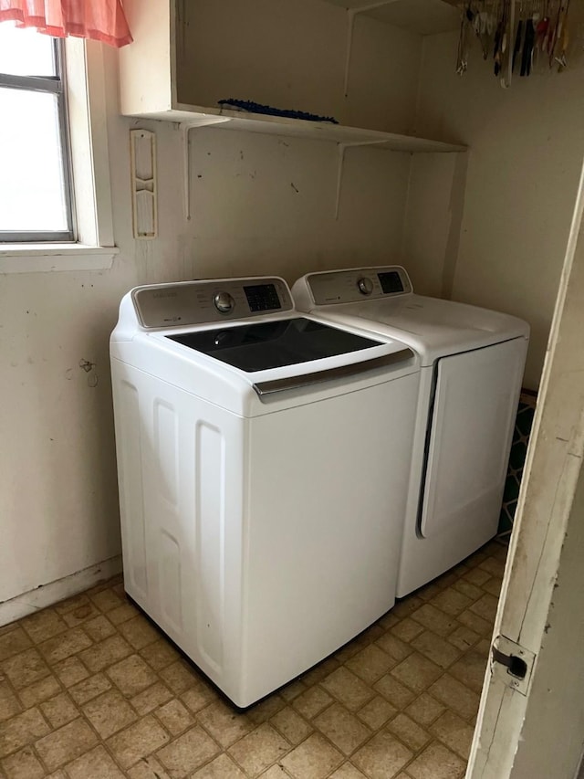 clothes washing area featuring washer and clothes dryer