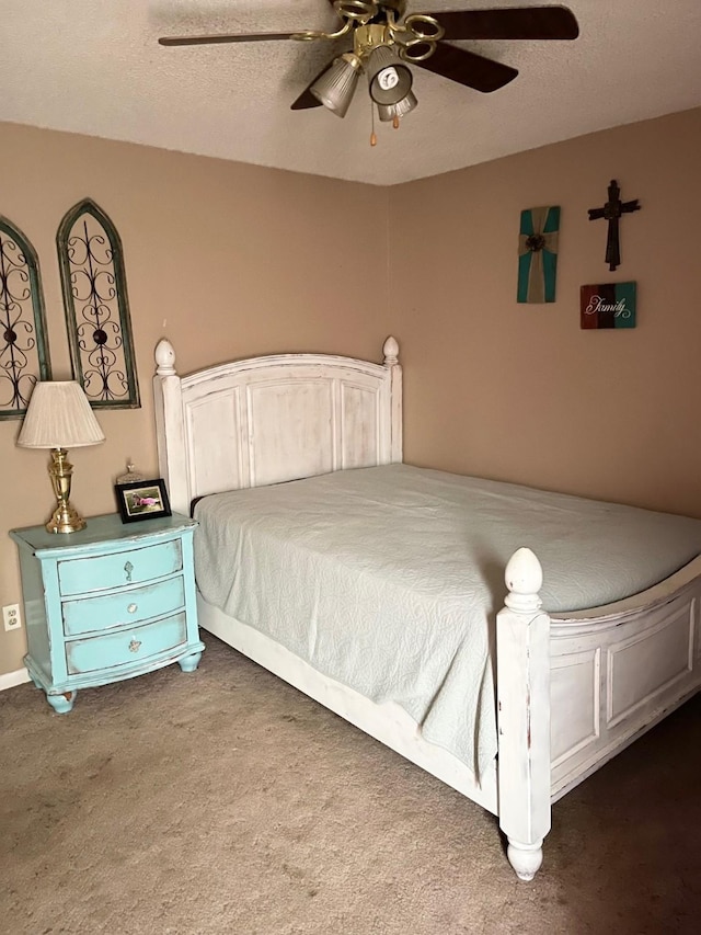 bedroom featuring dark colored carpet, ceiling fan, and a textured ceiling