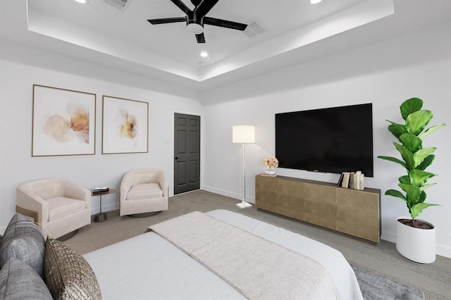 bedroom featuring a tray ceiling, ceiling fan, and carpet