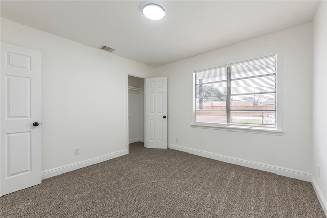 unfurnished bedroom with carpet and a closet