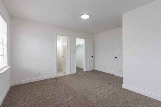 unfurnished room featuring light colored carpet and a wealth of natural light