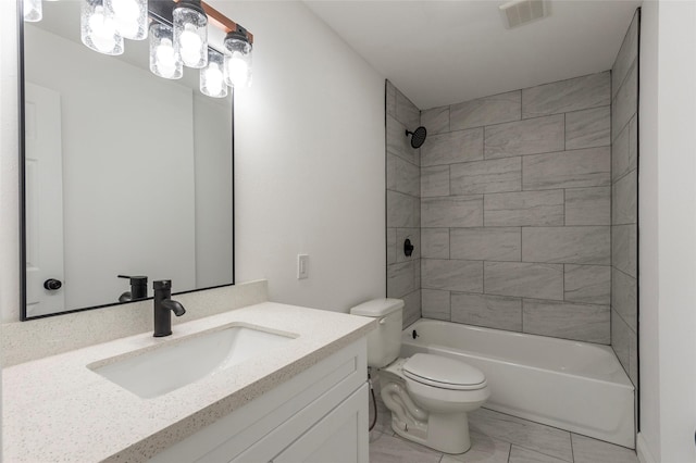 full bathroom featuring vanity, toilet, and tiled shower / bath