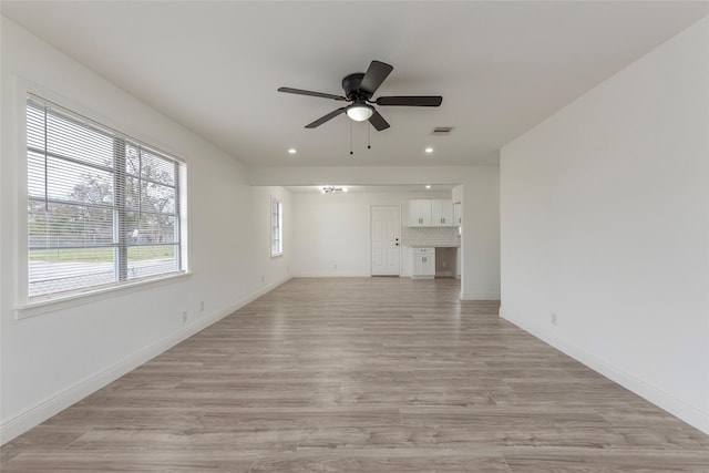 unfurnished living room featuring light hardwood / wood-style flooring and ceiling fan