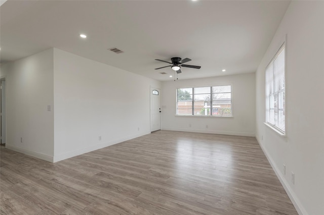 empty room featuring ceiling fan and light hardwood / wood-style flooring