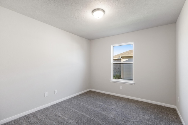 carpeted spare room featuring a textured ceiling