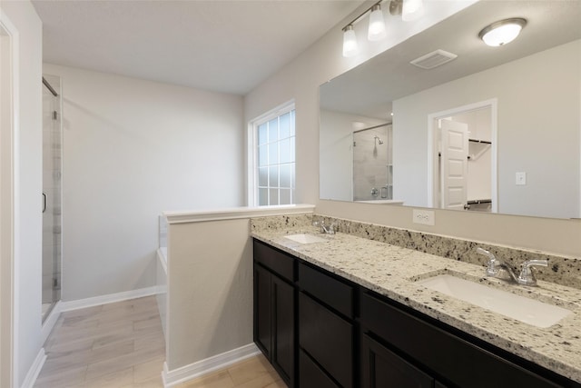 bathroom with vanity and a shower with shower door