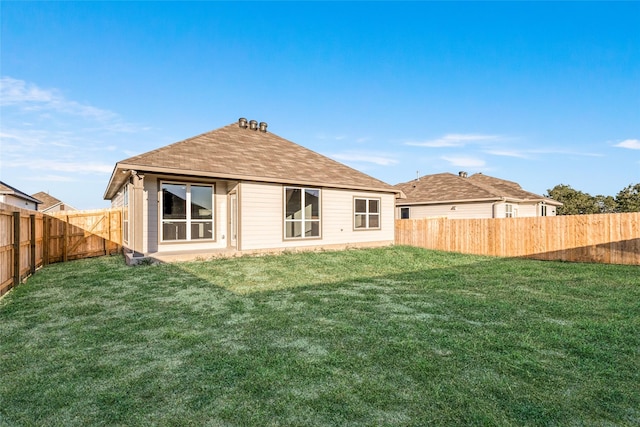 back of house featuring a yard