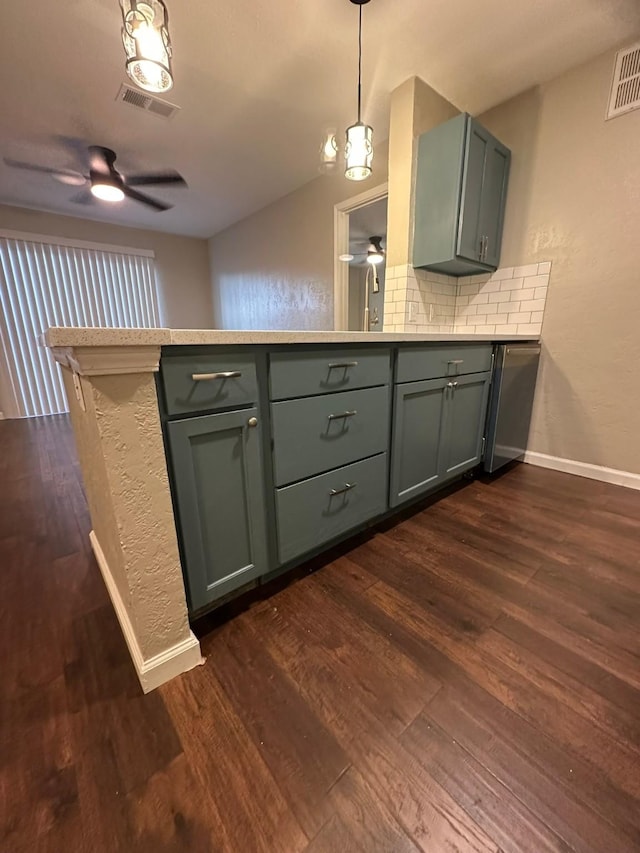 kitchen featuring backsplash, ceiling fan, dark hardwood / wood-style flooring, and hanging light fixtures