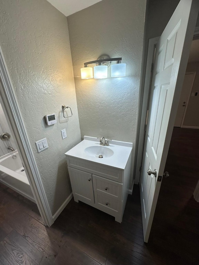 bathroom with hardwood / wood-style floors and vanity