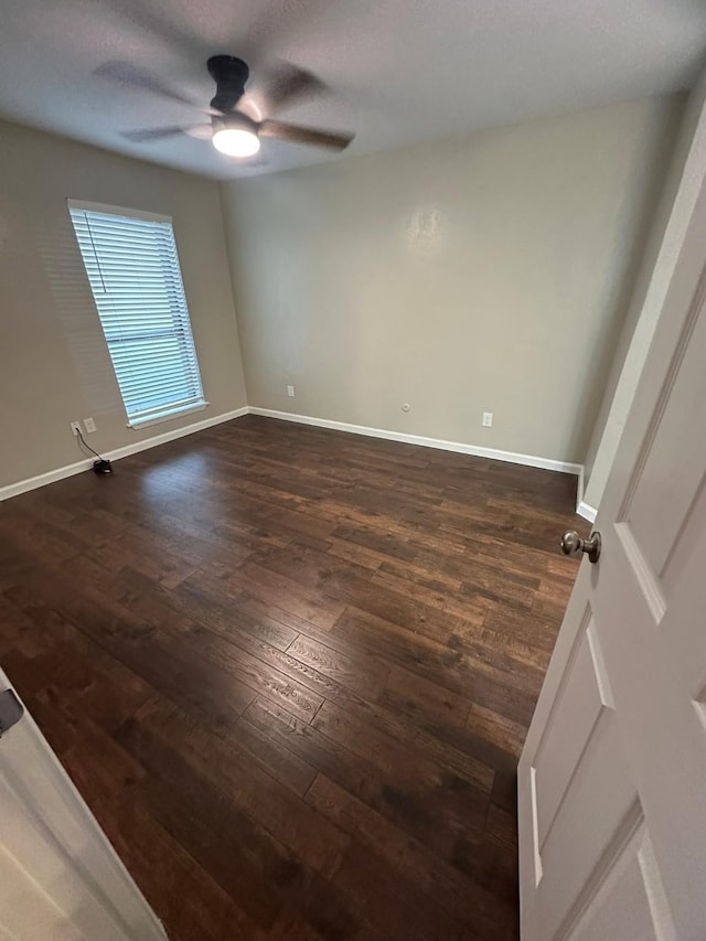 unfurnished room with ceiling fan, dark hardwood / wood-style flooring, and a textured ceiling