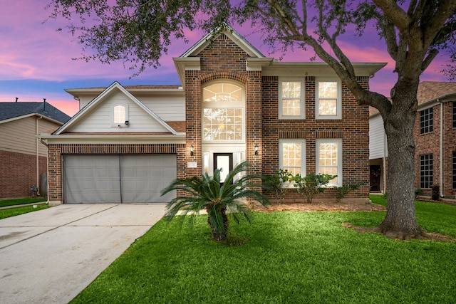 view of front property featuring a garage and a yard