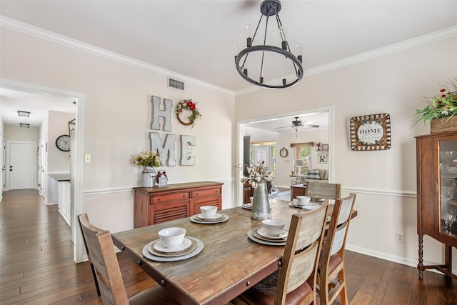 dining room with ceiling fan with notable chandelier, crown molding, and dark hardwood / wood-style floors