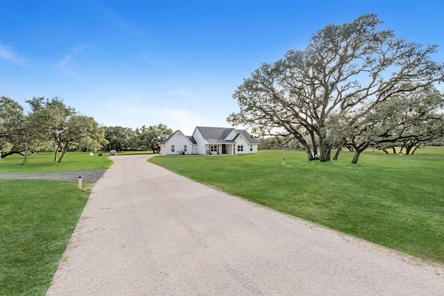 cape cod-style house featuring a front yard