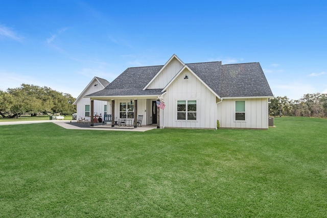 back of house with a lawn and a patio area