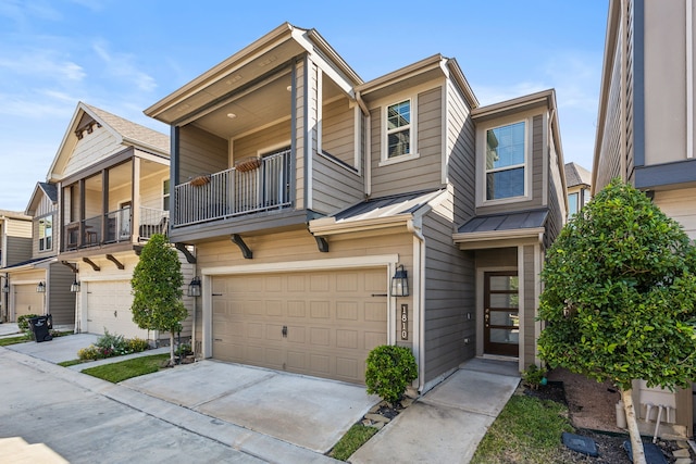 townhome / multi-family property featuring a balcony and a garage