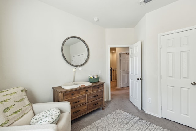 living area featuring light carpet